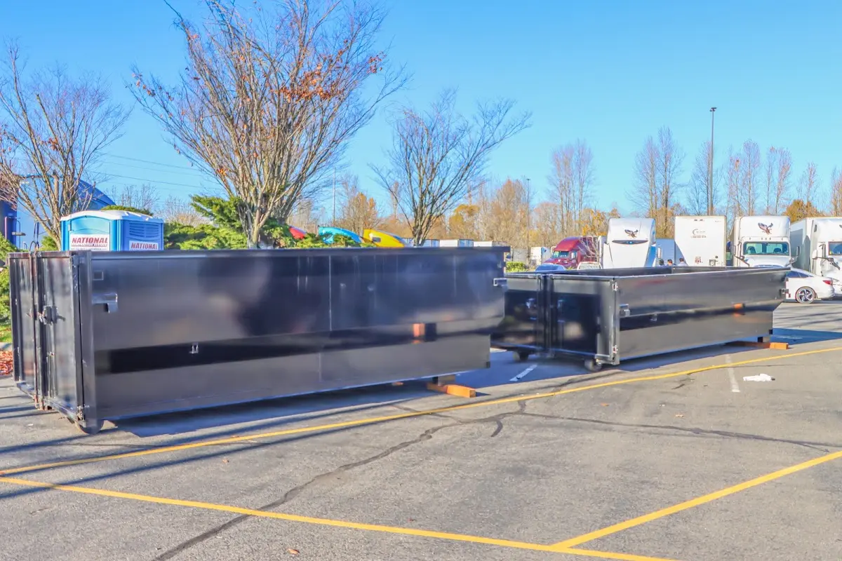 Professional dumpster rental service with roll-off container on residential driveway in Fillmore